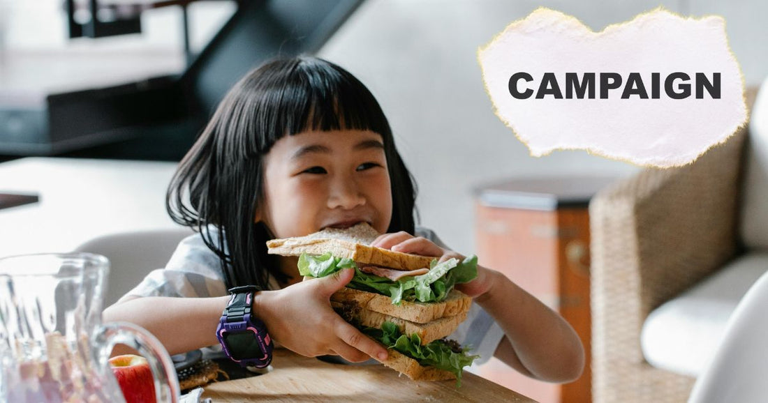 CAMPAINGの文字と大きなサンドイッチを食べる少女